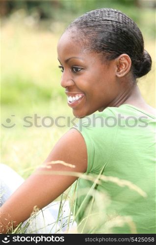 African woman sitting in the grass