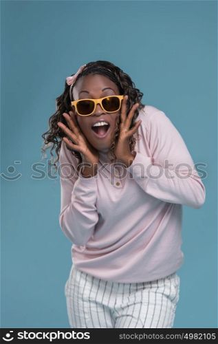 African woman wearing sunglasses and expressing positivity
