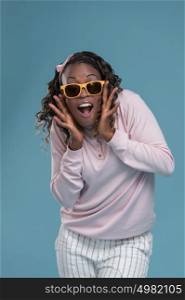 African woman wearing sunglasses and expressing positivity
