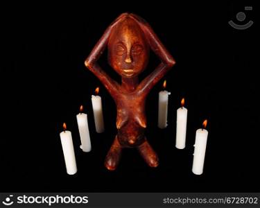 African Wooden Figure, Praying Before the Candle in the Dark