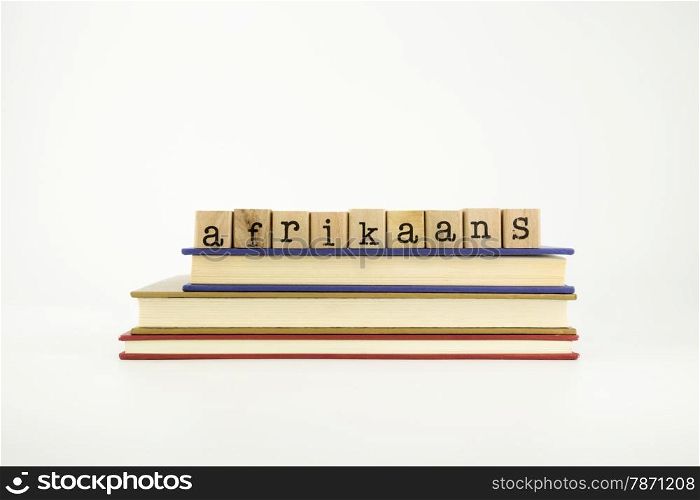 afrikaans word on wood stamps stack on books, language and conversation concept
