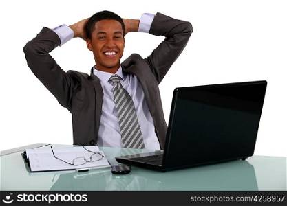 Afro-American businessman relaxing at his desk
