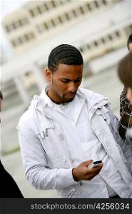 Afro-American man sending text message on phone