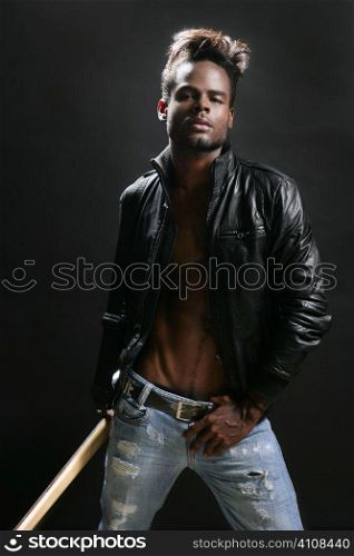 Afro american rock star musician with leather jacket and bass guitar