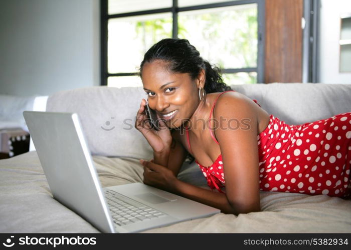 Afro-American woman relaxing on the couch