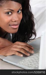 Afro-American woman using laptop