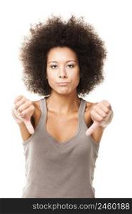 Afro-American young woman isolated on white doing a thumbs down signal with her hand