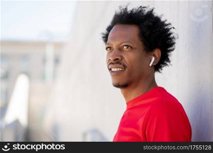 Afro athletic man standing outdoors on the street. Sport and healthy lifestyle.