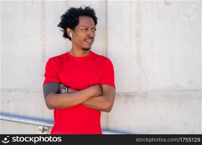 Afro athletic man standing outdoors on the street. Sport and healthy lifestyle.