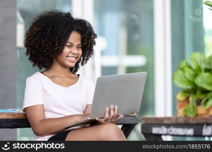 Afro girl curly hair using laptop searching market online for organic vegetables.smarth farming.Freshness concept.