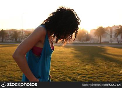 Afro woman walking in the city park