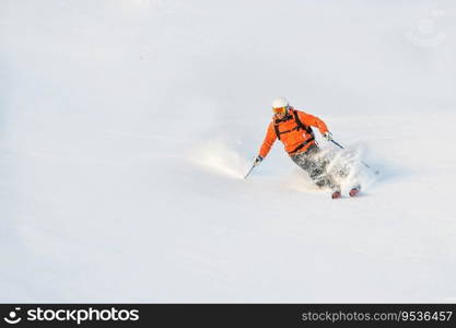 After seal skin ascent a skier has fun in powder snow