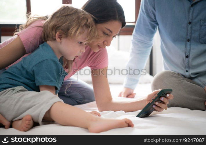 After the little boy wakes up from his nap, his father and mother engage in enjoyable activities in his bedroom.