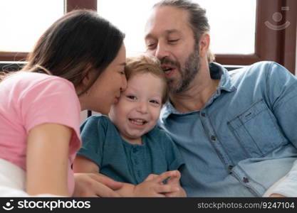 After the little boy wakes up from his nap, his father and mother engage in enjoyable activities in his bedroom.