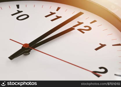 Afternoon 12 o’clock time clock face closeup for lunch brake business working hours.