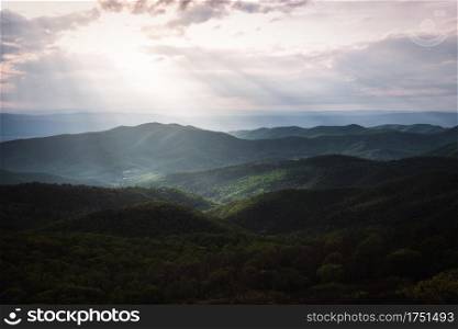 Afternoon rays of light shine down into the valleys of Shenandoah National Park, viewed from the summit of Bearfence Mountain.