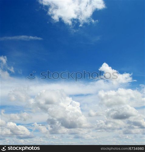 against the blue sky cumulus clouds