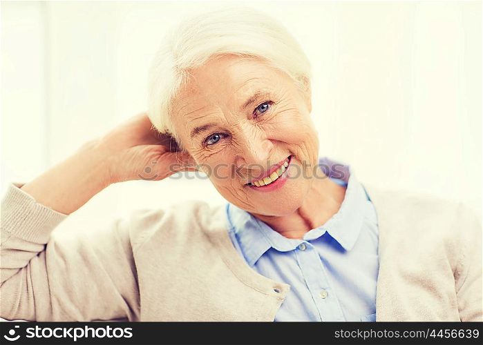 age and people concept - happy smiling senior woman at home. happy senior woman face at home