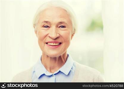 age and people concept - happy smiling senior woman face at home. happy senior woman face at home