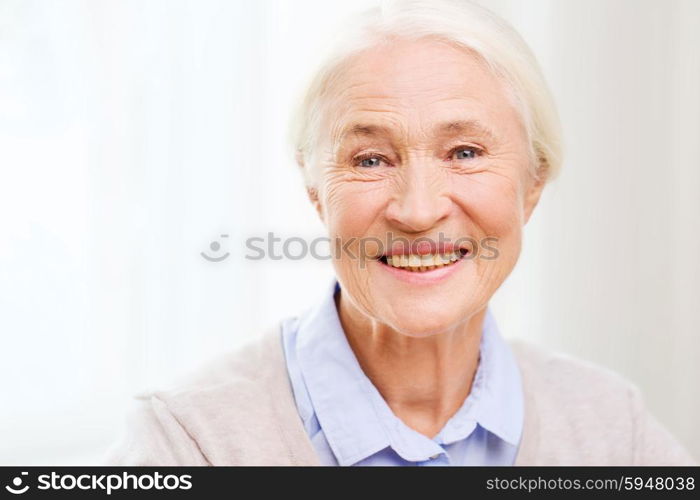 age and people concept - happy smiling senior woman face at home. happy senior woman face at home