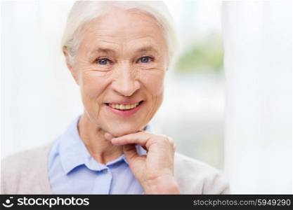 age and people concept - happy smiling senior woman face at home. happy senior woman face at home
