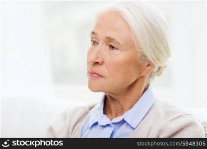 age, emotion, sadness and people concept - senior woman face at home