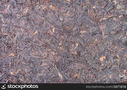 Aged chinese puer tea brick as background