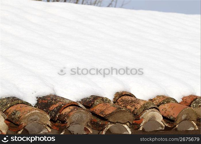 aged clay roof tiles snowed under snow architecture detail