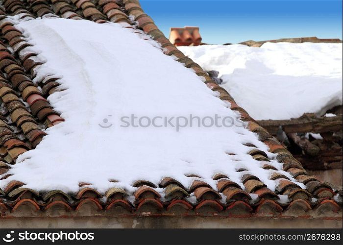 aged clay roof tiles snowed under snow architecture detail
