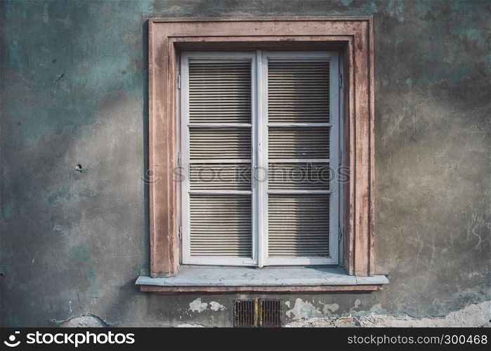 Aged european wall with wooden old-fashioned stylish window