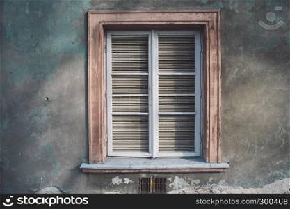Aged european wall with wooden old-fashioned stylish window