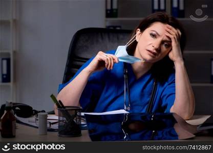 Aged female doctor working at night shift 