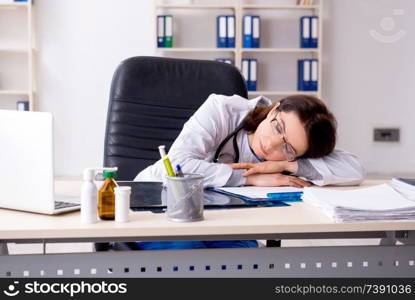 Aged female doctor working in the clinic 