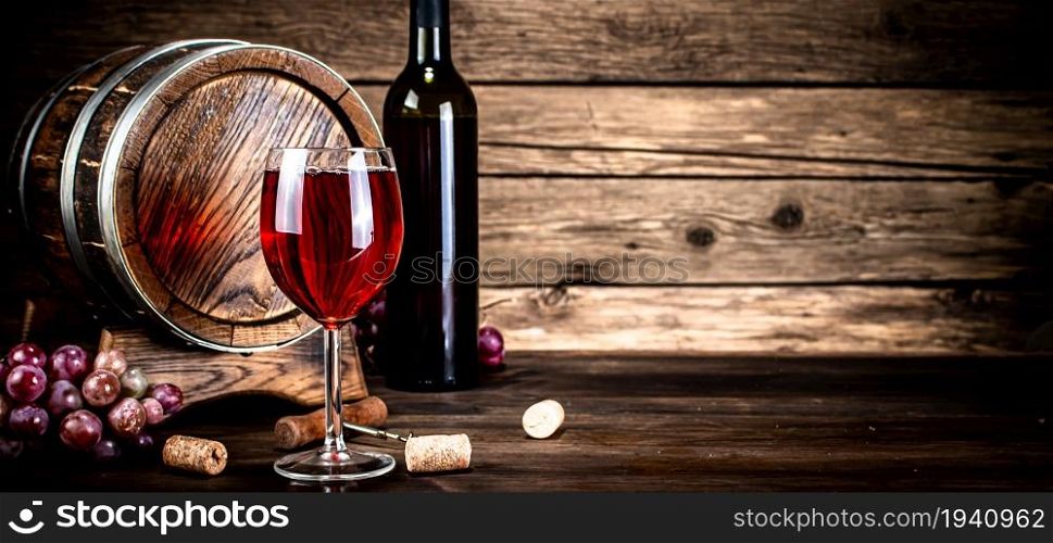 Aged grape wine in a glass on the table. On a wooden background.. Aged grape wine in a glass on the table.