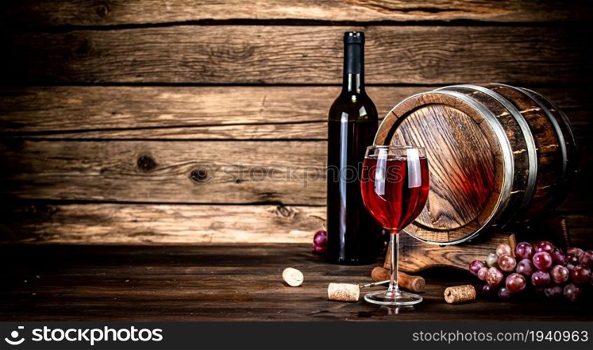 Aged grape wine in a glass on the table. On a wooden background.. Aged grape wine in a glass on the table.