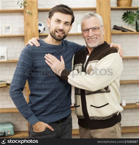 aged happy man touching hugging with young smiling guy
