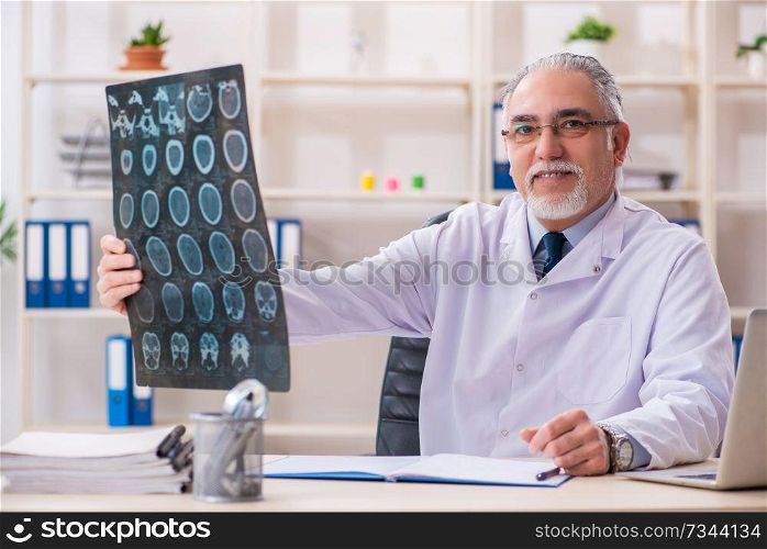 Aged male doctor radiologist in the clinic 