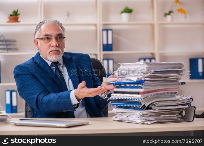 Aged male employee working in the office 