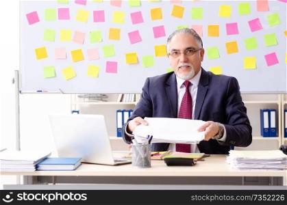 Aged man employee in conflicting priorities concept 