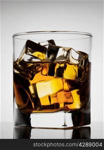 Aged noble glass of whiskey with ice