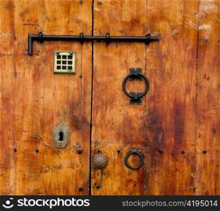 Aged old golden wood door from Ibiza downtown