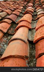 Aged old red clay arabic roof tiles, traditional architecture roofing in Spain