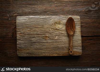 Aged wood cutting board copyspace background with olive tree wood spoon
