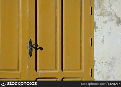 Aged wooden color door in mediterranean