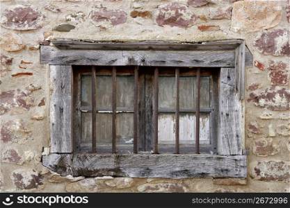 Aged wooden window in masonry stone walls house in Navarra Pyrenees Spain
