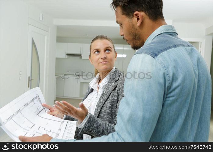 agent looking at propertys floorplan with client