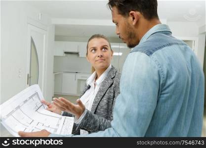 agent looking at propertys floorplan with client