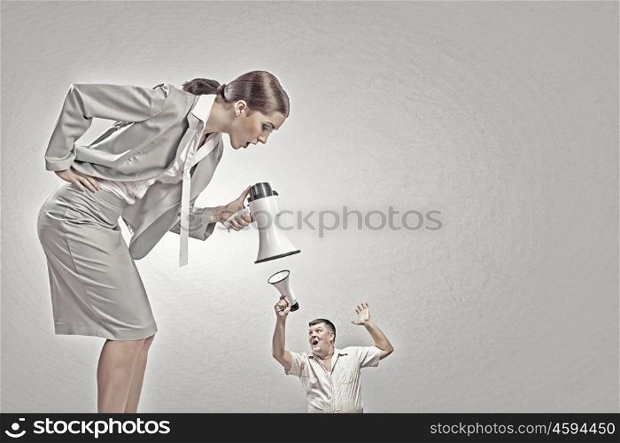 Aggression and humiliation in communication. Aggressive businesswoman screaming in megaphone on her colleague