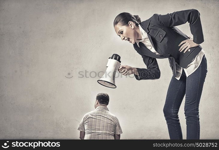 Aggression and humiliation in communication. Aggressive businesswoman screaming in megaphone on her colleague