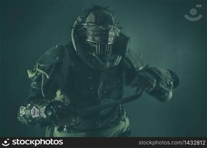 Aggressive and evil humanoid monster or creature of post apocalyptic, poisoned by dangerous pollution world wearing tattered rags and gas mask, brandishing bloodstained machete studio shoot on white. Post apocalyptic human threatening with cane knife